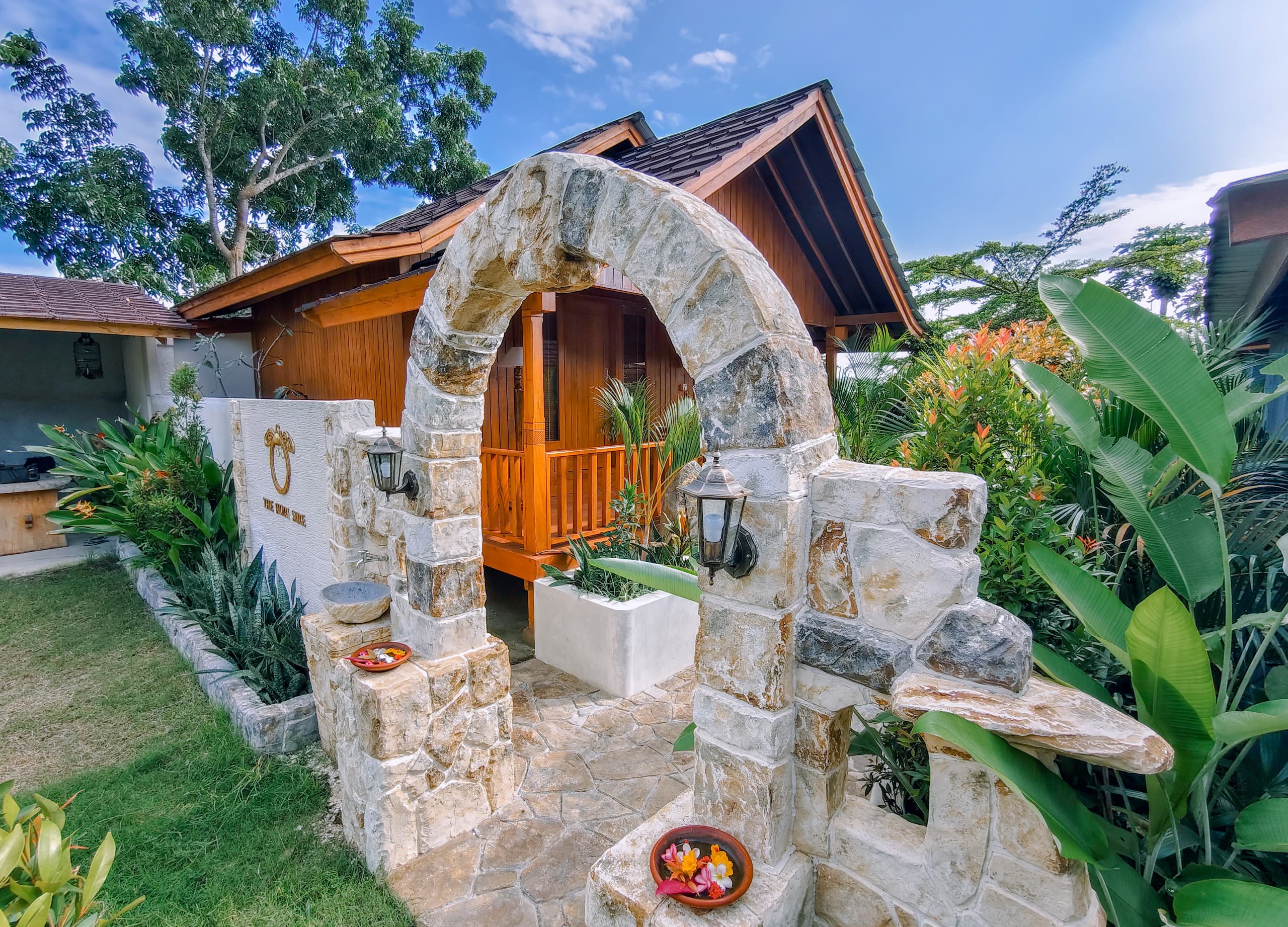 The Kori Sire wooden villa hero exterior at golden hour, North Lombok
